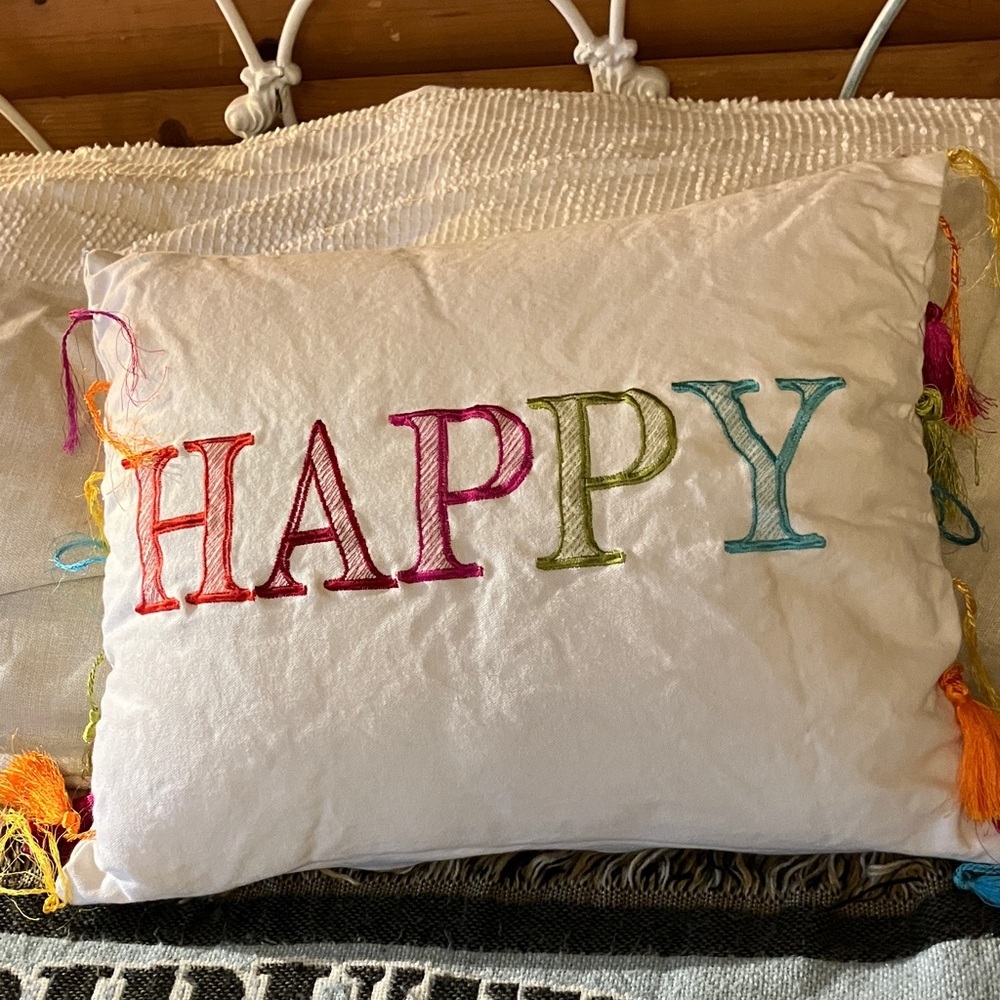 Rainbow fringed “happy” throw pillow